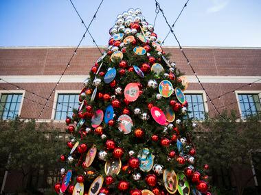 A Christmas tree decorated with ornaments made by elementary school children is displayed in...