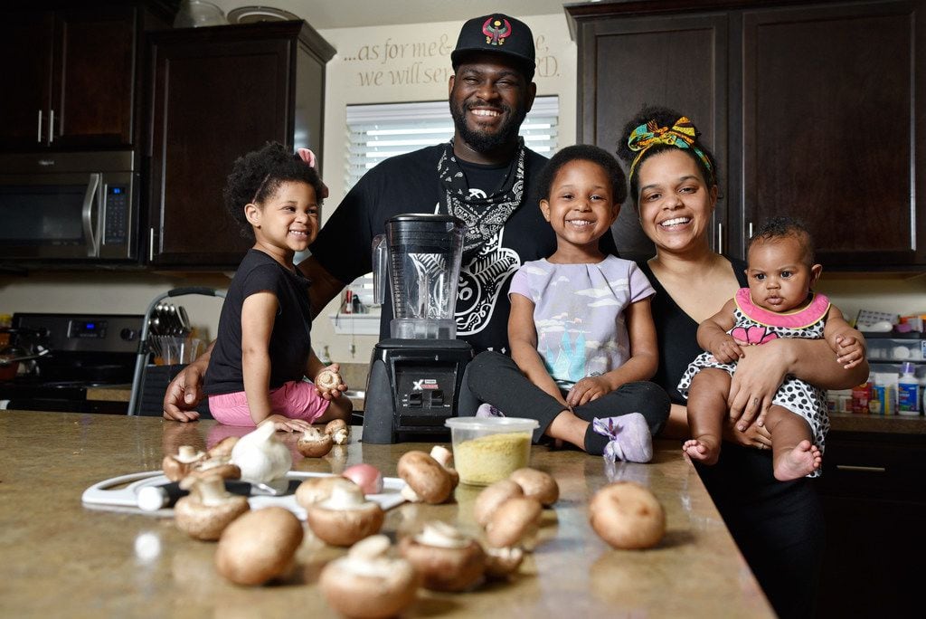 James McGee, owner of the vegan restaurant Peace Love & Eatz in DeSoto, with his family...