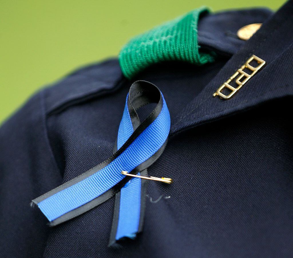 A Dallas Police officer wore a blue ribbon during the Tribute 7/7 memorial event at Dallas City Hall Plaza last year.
