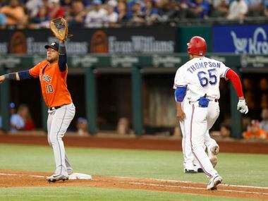 Houston Astros first baseman Yuli Gurriel (10) stretches to catch the ball and force out...