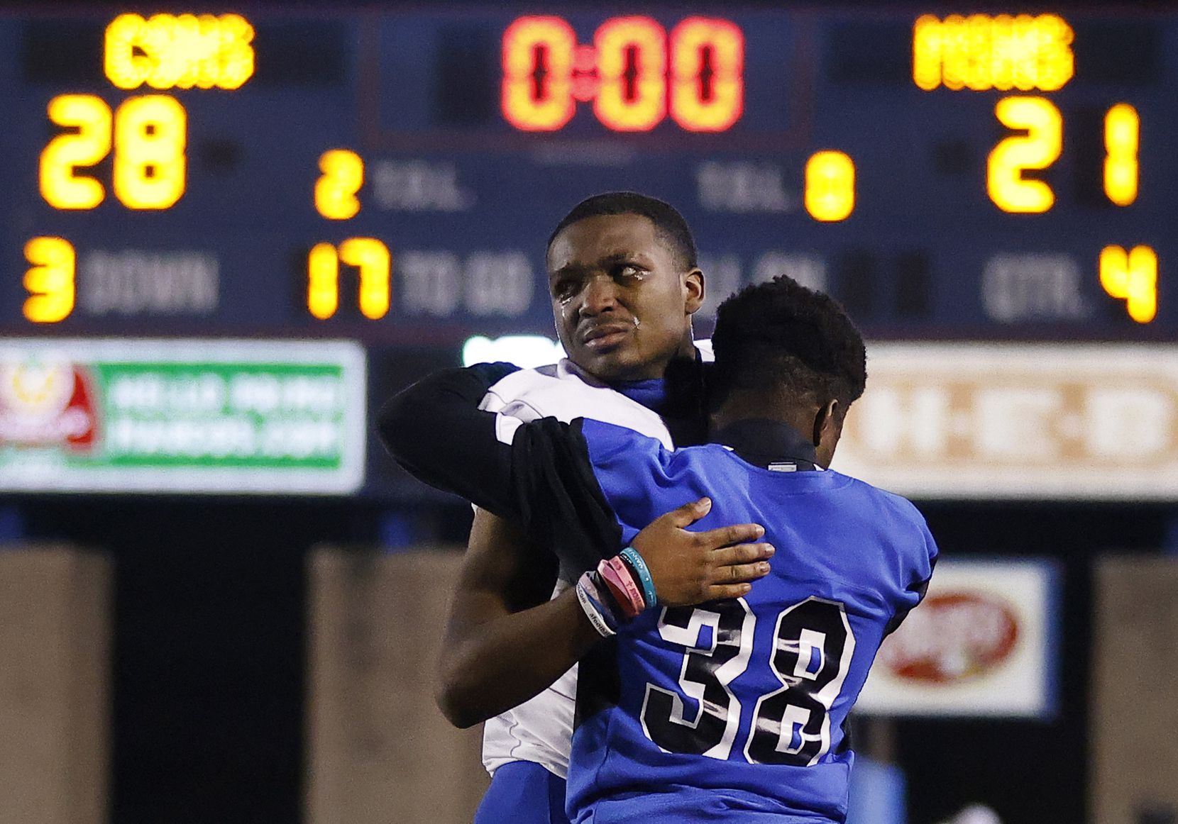 Mansfield Summit senior defensive player Aiden Armstrong (facing) receives a consoling hug...