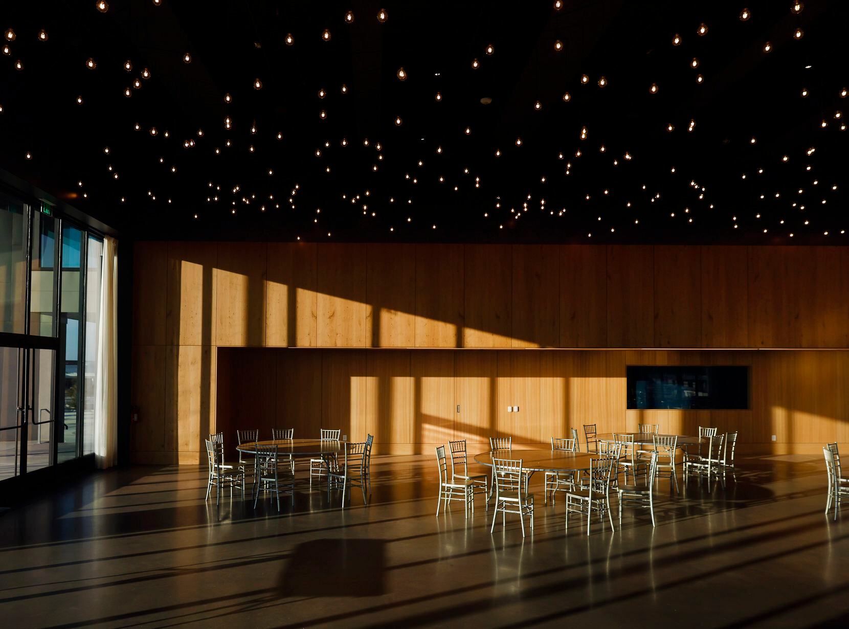 Star-cluster ceiling lights run the length of an event space at the St. Sarkis community...