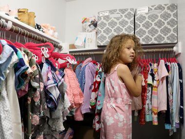 Lincoln Brooks, 4, picks out her pajamas for the night at the Brooks’ home in Sherman on...