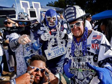 Dallas Cowboys super fans pose for a photo at a tailgate party before the Monday Night...