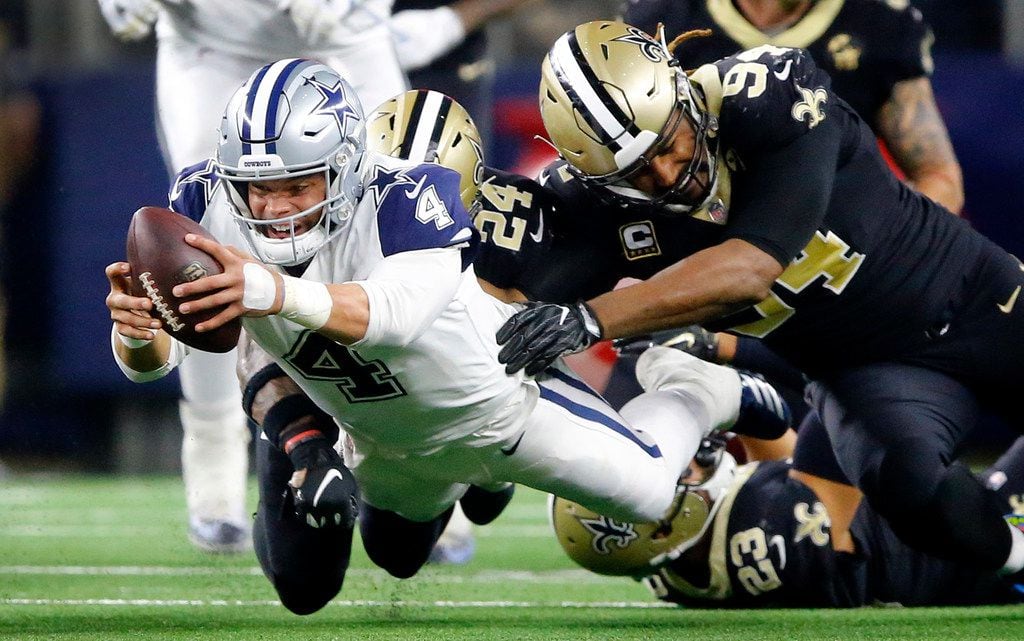 Dallas Cowboys quarterback Dak Prescott (4) dives for extra yards and a first down as he's...