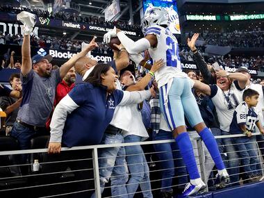 Dallas Cowboys safety Israel Mukuamu (24) crawls up in the suites to celebrate their win...