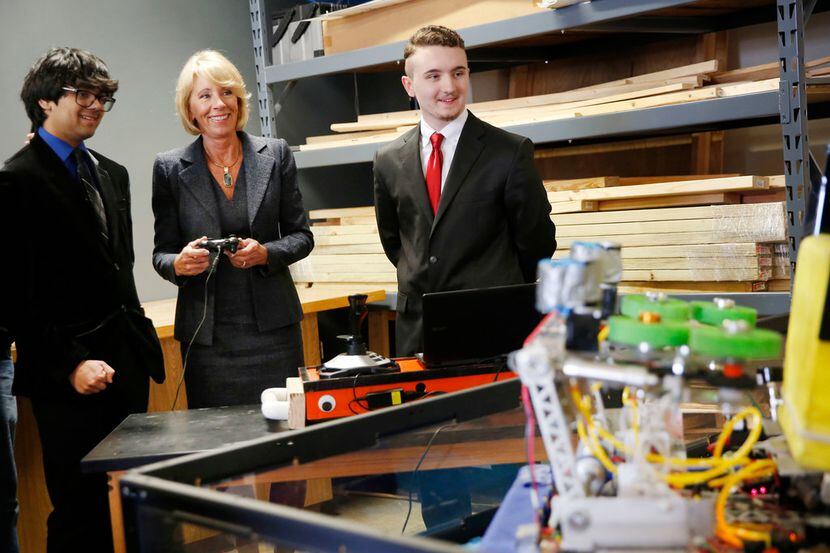 U.S. Secretary of Education Betsy DeVos operates a robot with Haltom High School students...