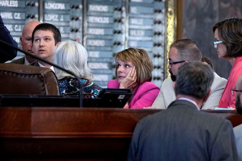 Texas state Rep. Stephanie Klick, center, listens to House parliamentarian Hugh Brady during...