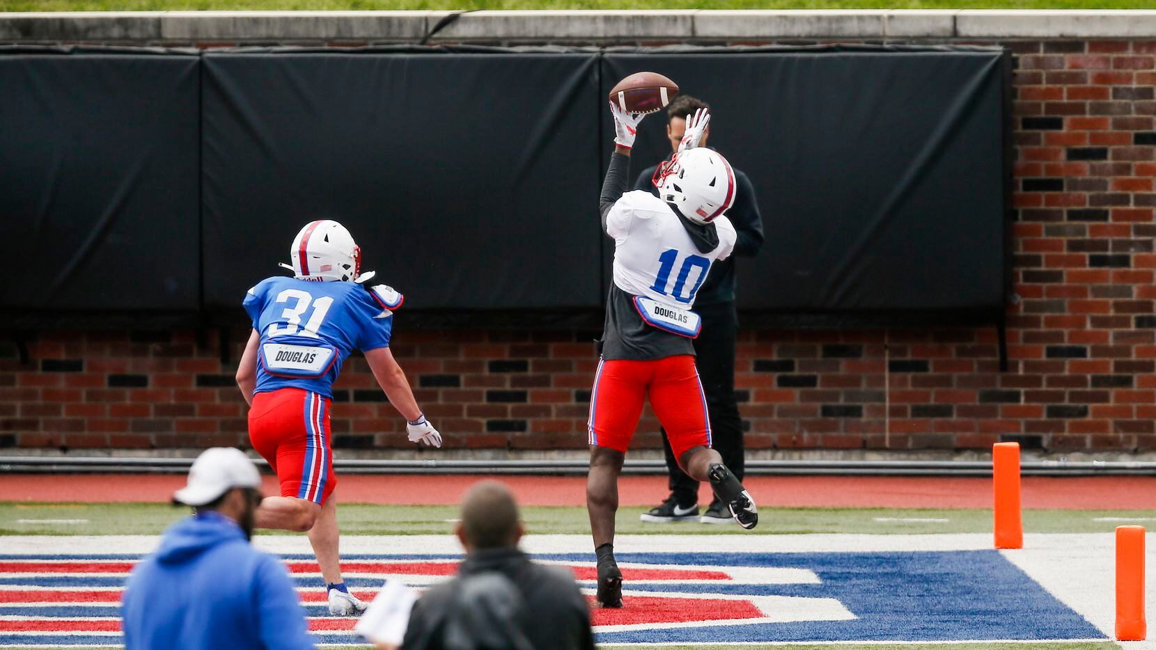 SMU wide receiver Dylan Goffney (10) catches a pass as SMU safety Tripp McAda (31) defends during practice at Gerald Ford Stadium, Saturday, April 17, 2021.