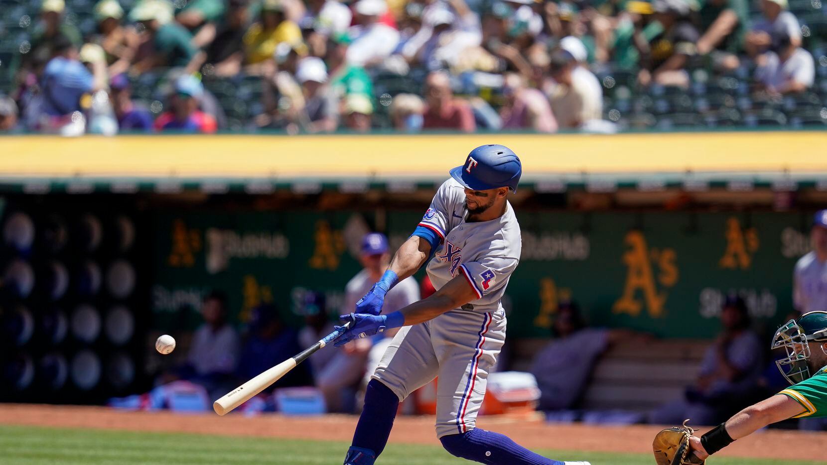 Texas Rangers' Leody Taveras hits an RBI-single against the Oakland Athletics during the...