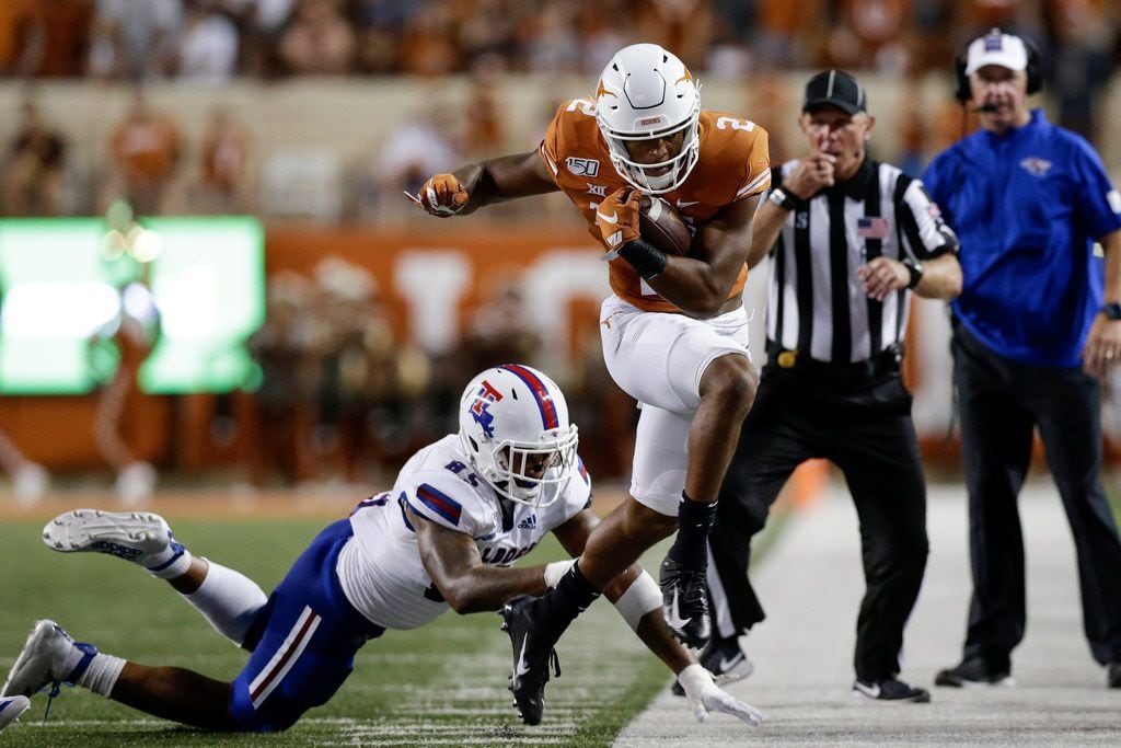 AUSTIN, TX - AUGUST 31:  Roschon Johnson #2 of the Texas Longhorns is forced out of bounds by Willie Baker #85 of the Louisiana Tech Bulldogs in the second quarter at Darrell K Royal-Texas Memorial Stadium on August 31, 2019 in Austin, Texas. 