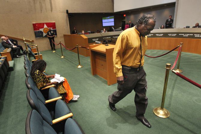 William Hopkins leaves the podium after he pleaded for the Dallas City Council to respond to his remarks while talking about a friend of his who is dying in the hospital.  He has been attending council meetings regularly since 1996 to try to get help for the residents of West Dallas.