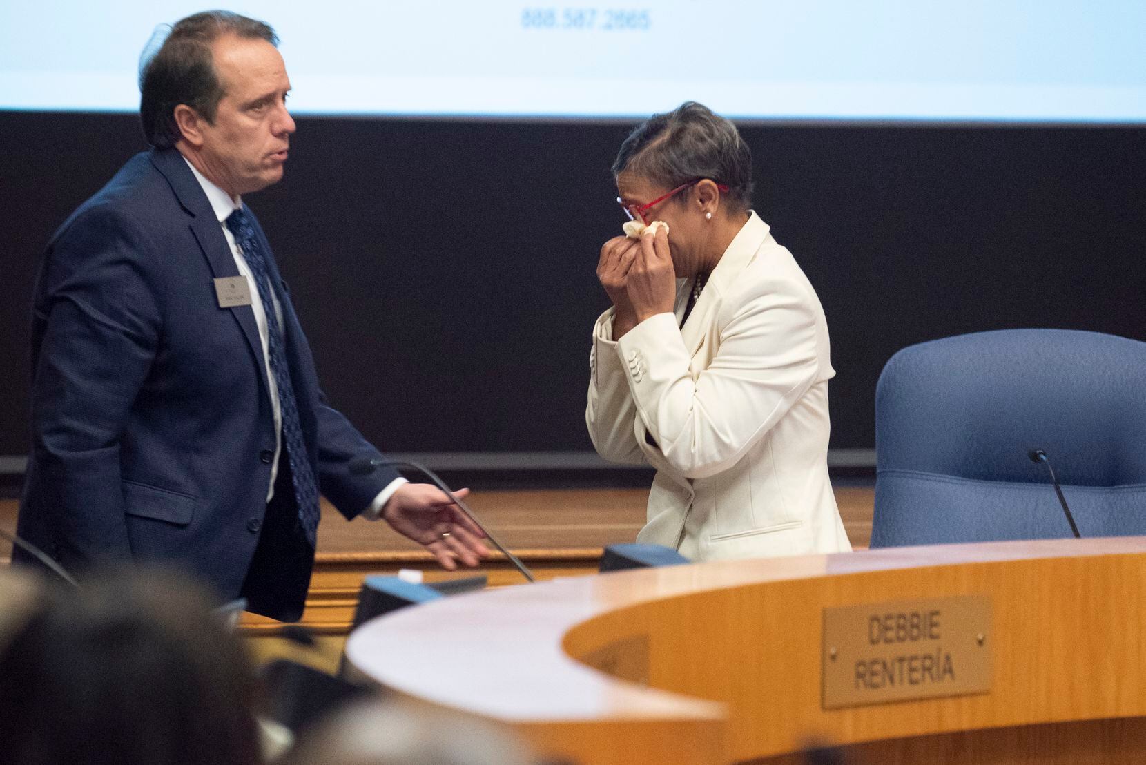 School board President Regina Harris, right, uses a tissue to wipe her tears as she walks out of the board room after making the announcement that the RISD board as accepted Superintendent Stone's resignation, during a school board meeting Monday night at the RISD Administration building,  Dec. 13, 2021 in Richardson.