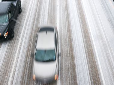Cars move along icy roads on U.S. 75 near Skillman Street in Dallas on Tuesday, Jan. 31,...
