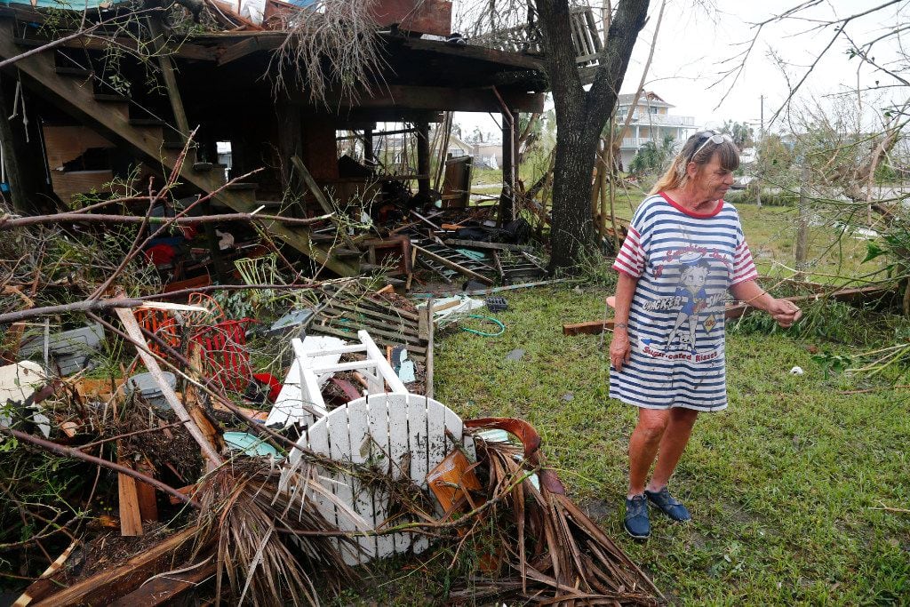 Paulette Rogers looks at her destroyed pineapple tree after Hurricane Harvey destroyed their house in Port Aransas, Texas on Aug. 26, 2017.   (Nathan Hunsinger/The Dallas Morning News)