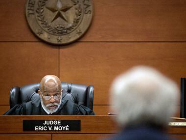 Judge Eric Moyé (left) speaks with an attorney during a civil case in 2016 at the George Allen Courts Building in Dallas.