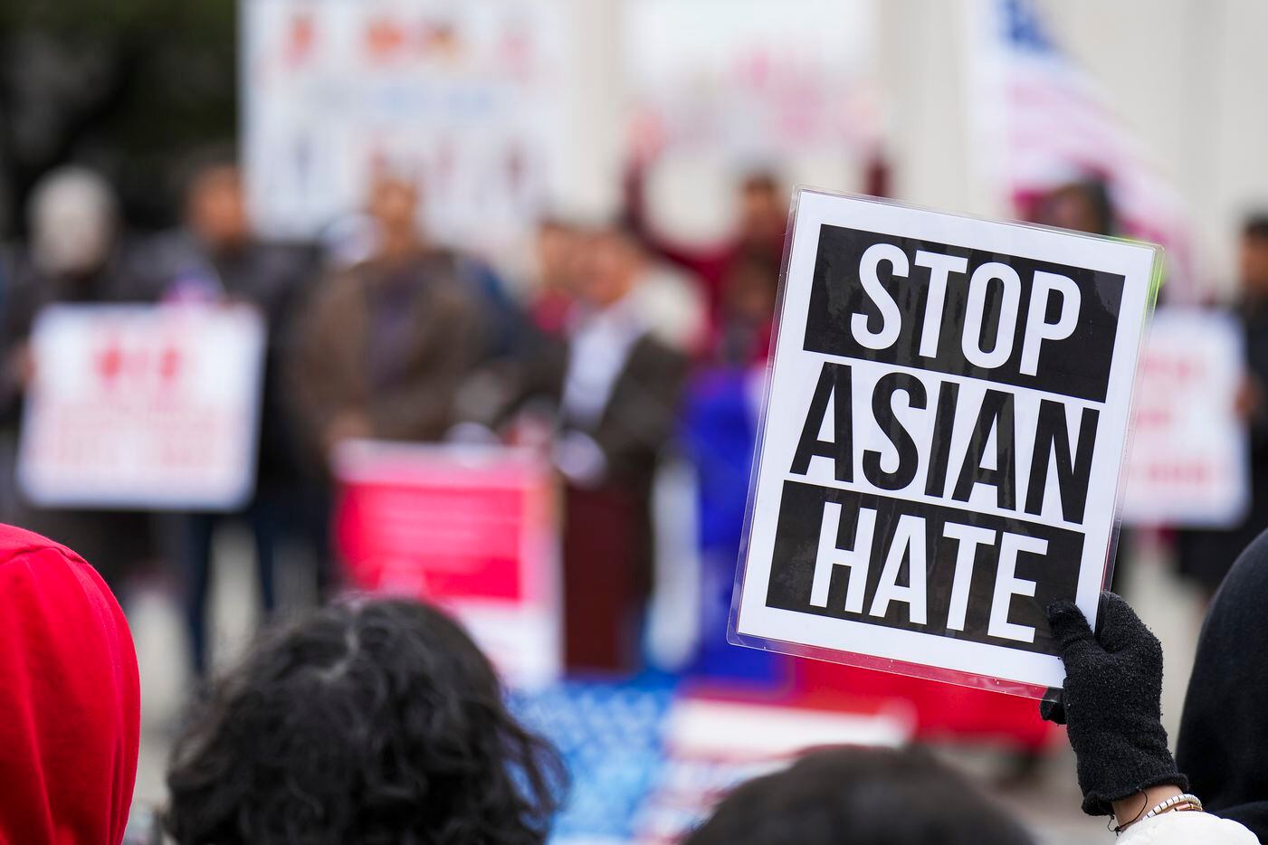 A woman holds a sign reading “Stop Asian Hate” during a rally in opposition to Texas Senate...