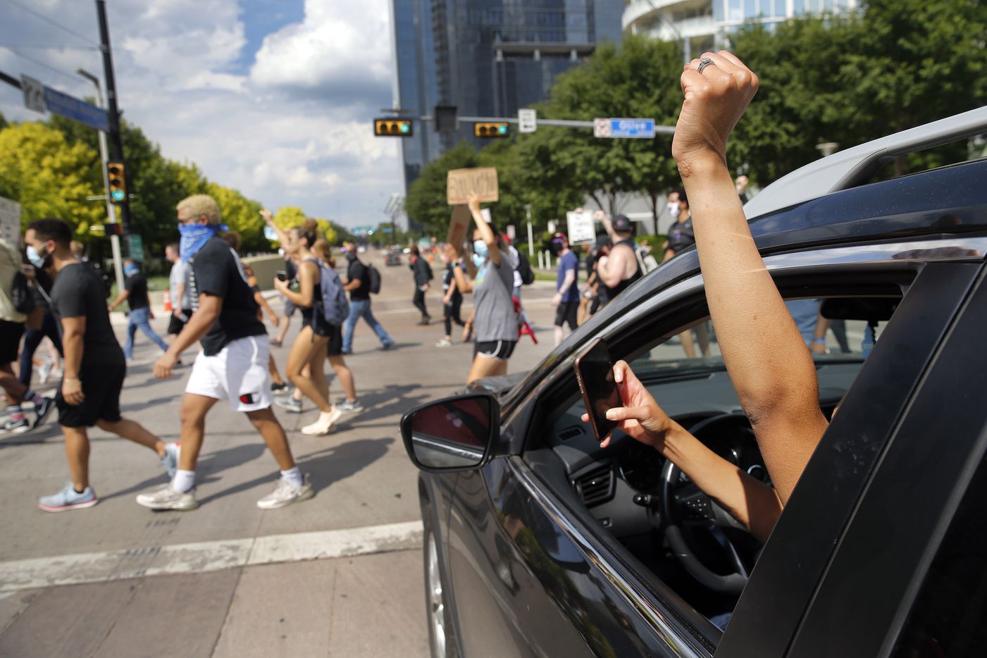 A supporter raises her first as protestors supporting Black Lives Matters march through...