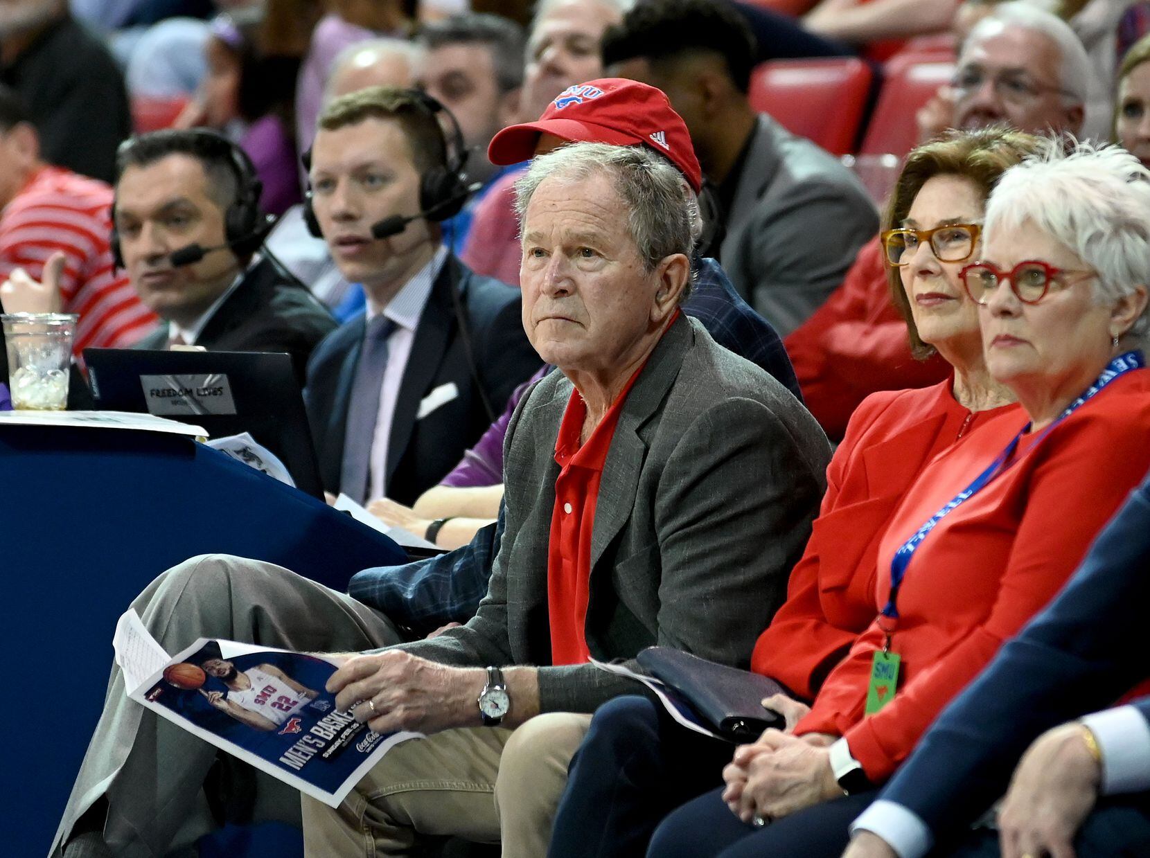 Former President George W. Bush watches play in the second half during a men’s NCAA...