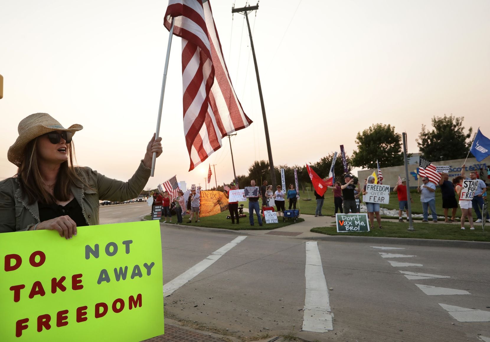Dozens of demonstrators gathered along the road near the Baylor Scott and White hospital campus in McKinney to protest vaccine mandates on Friday, Sept. 10, 2021.