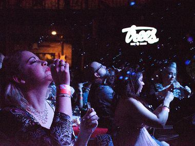 Audience members blow bubbles to bring on the next act at Trees in Deep Ellum.