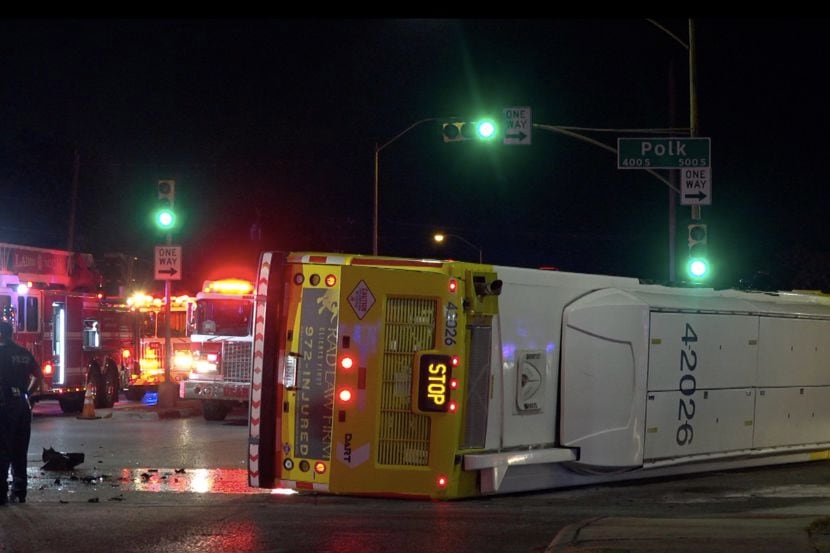 A DART bus lies on its side after it was struck at high speed by a Dodge Charger on Friday...
