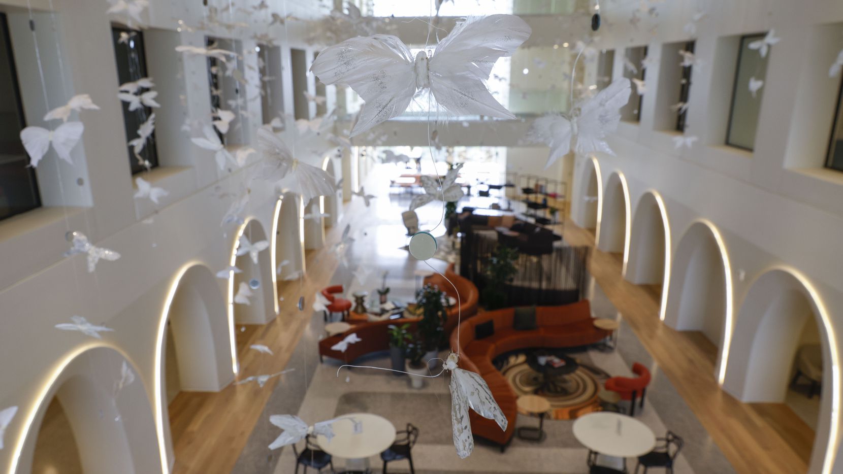 The retailer's signature butterflies hang from the ceiling in the atrium of the Neiman...