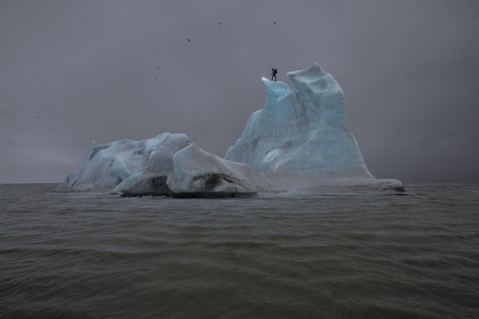 In Julian Charrière's 2013 photo "The Blue Fossil Entropic Stories III," the artist stands...