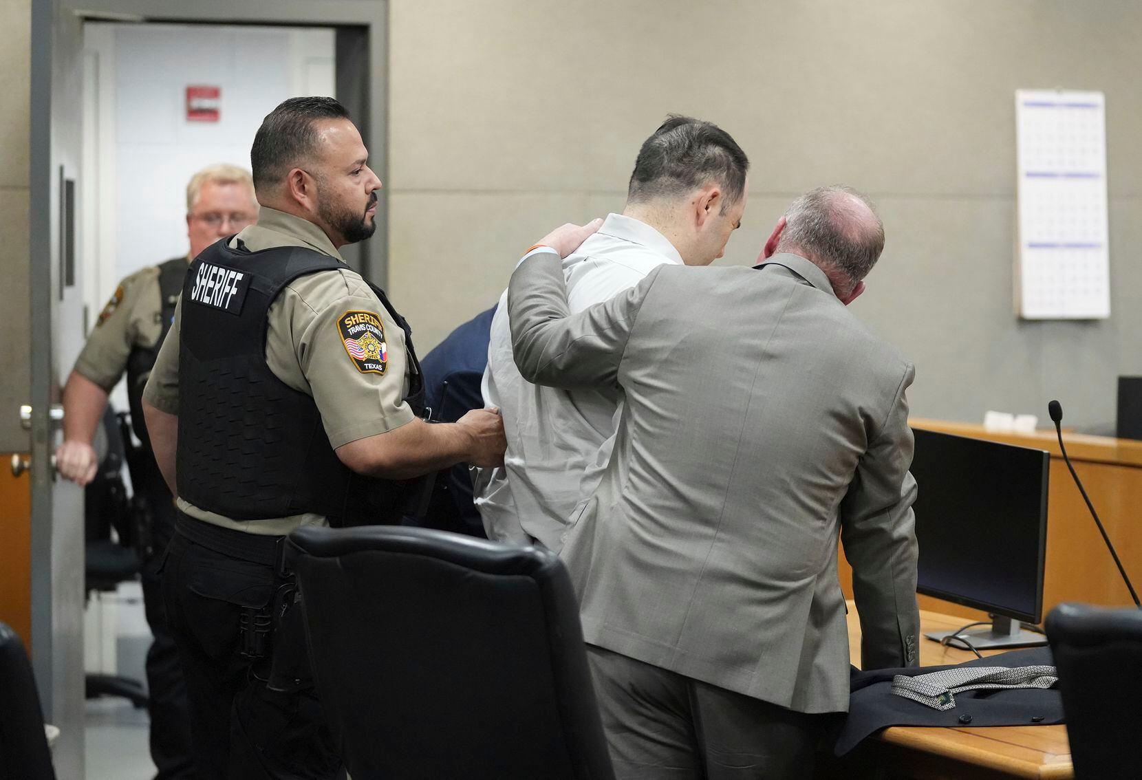 U.S. Army Sgt. Daniel Perry is comforted by his attorney Doug O'Connell after he was...