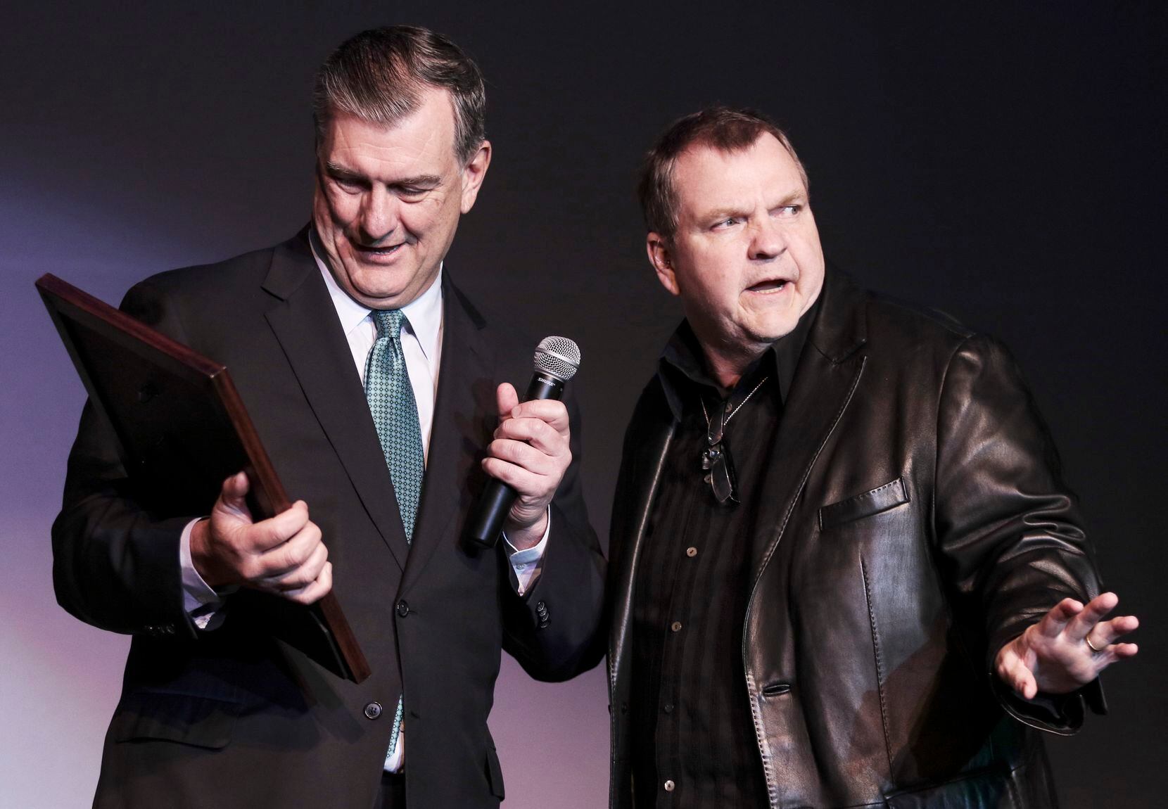 Former Dallas Mayor Mike Rawlings presents a plaque on behalf of the city to Meat Loaf, who...