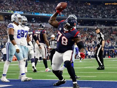 Houston Texans offensive tackle Laremy Tunsil (78) spikes the football after it being given...