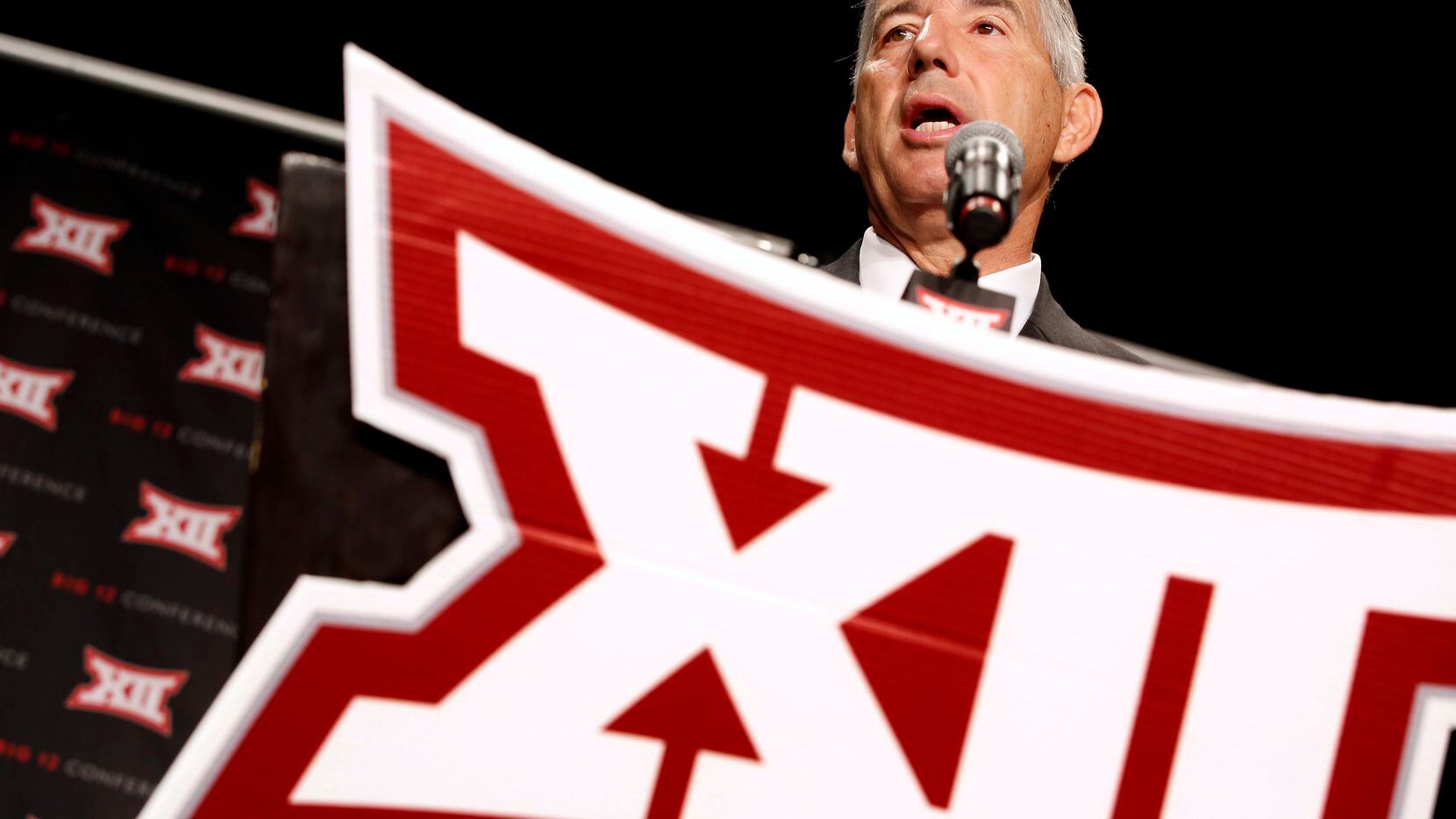 From behind the podium, Big XII Commissioner Bob Bowlsby address the media assembled for the...