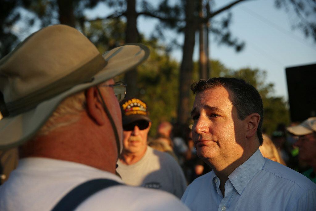 Texas senator Ted Cruz speaks to a mourner during a vigil along Avenue M and Highway 6...