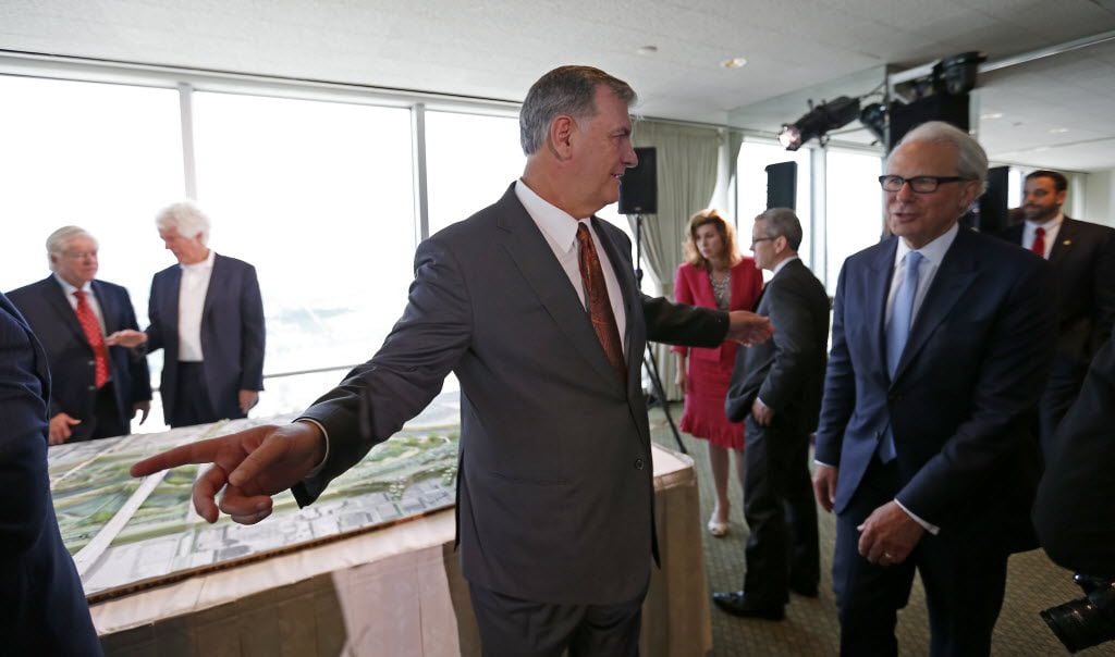 Mayor Mike Rawlings (left) talks with John H. Alschuler, chairman of HR&A, after a press...