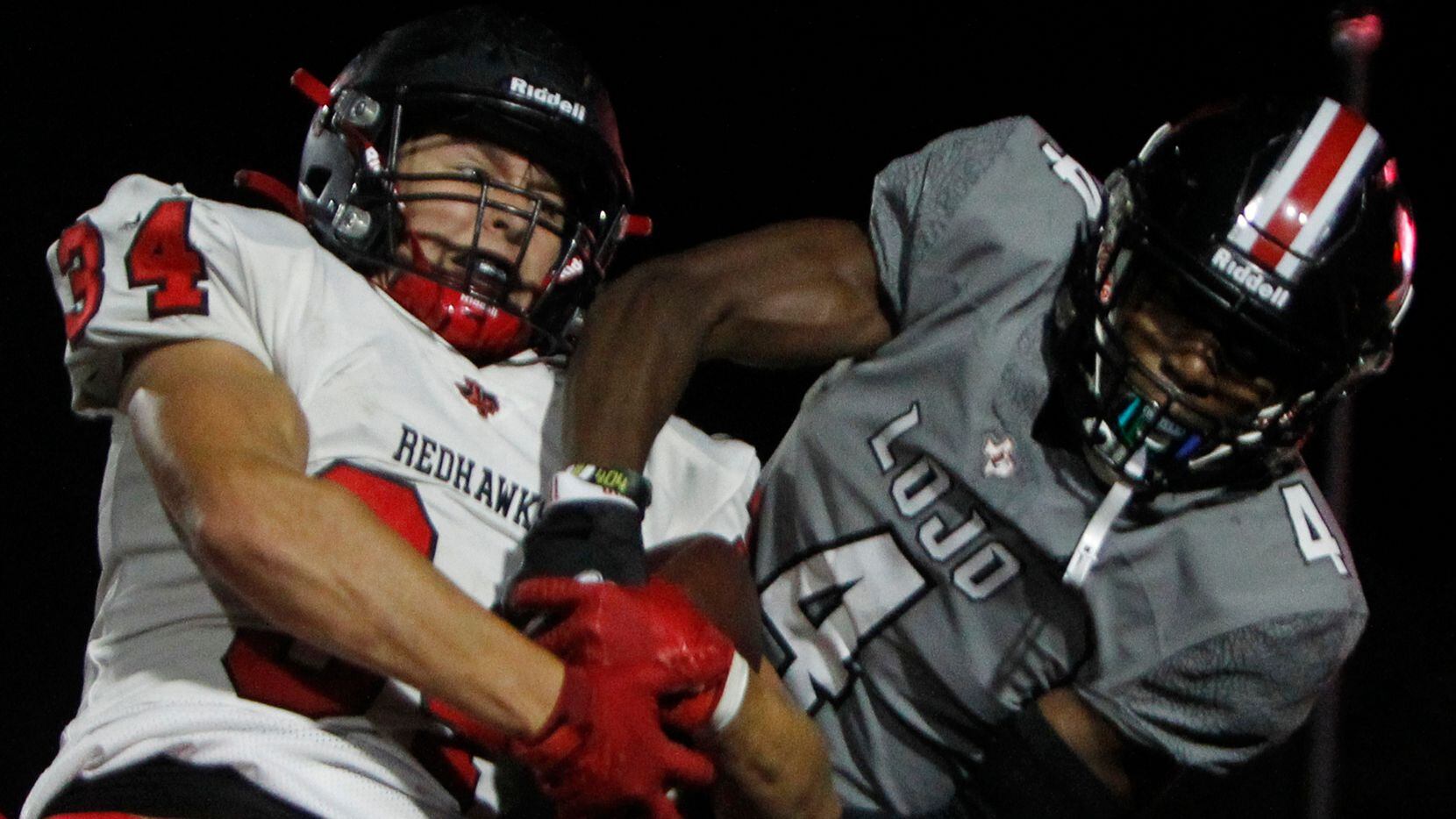 Frisco Liberty safety Sam Wenaas (34), left, wrestles away a pass  intended for Lucas...