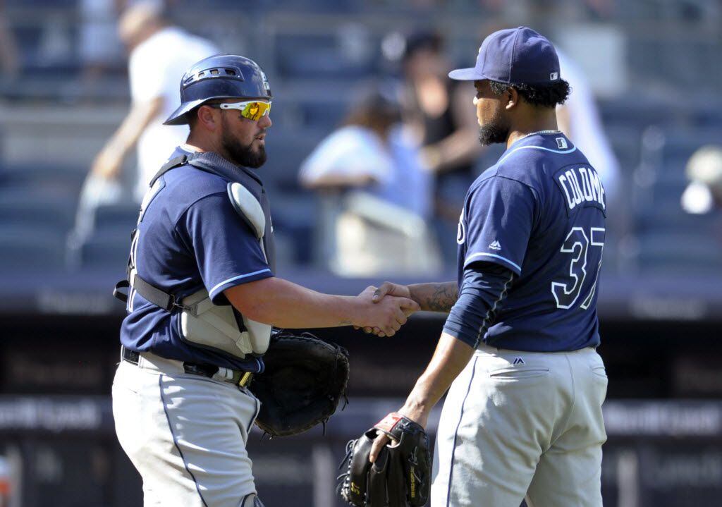 Tampa Bay Rays catcher Bobby Wilson, left, celebrates with pitcher Alex Colome after the...