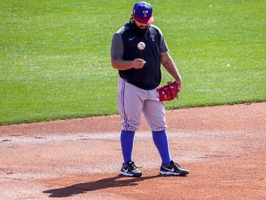 Texas Rangers infielder Rougned Odor tosses a ball while taking grounders at third base during a spring training workout at the team's training facility on Saturday, Feb. 27, 2021, in Surprise, Ariz.