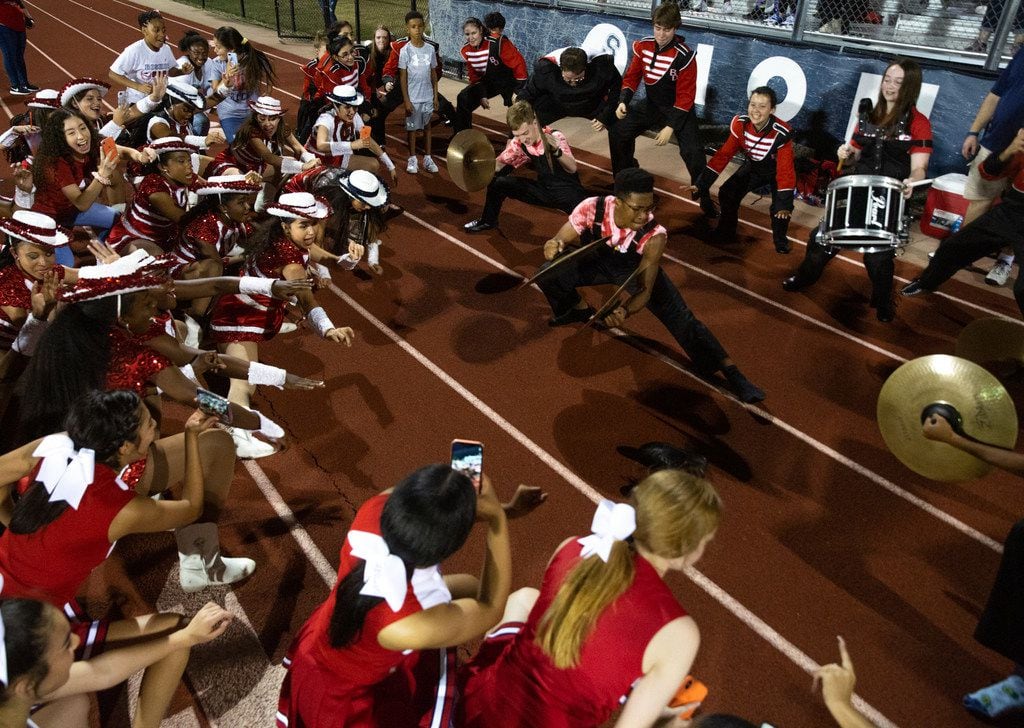 The Bishop Dunne Catholic School Falcon Band and cheerleaders perform "Funktrain," a winning-game ritual they did after their team defeated All Saints' Episcopal School at Young Field McNair Stadium in Fort Worth, Texas, on Friday, Sep. 27, 2019. (Lynda M. Gonzalez/The Dallas Morning News)