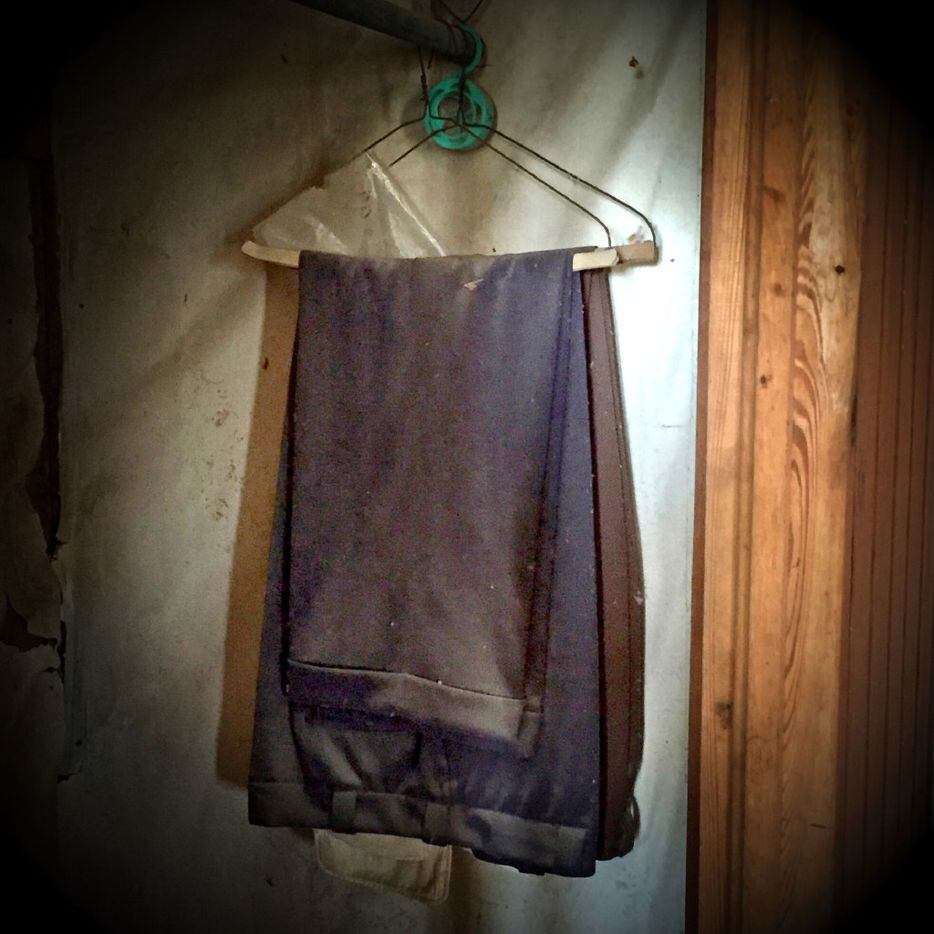 Men's pants still hang in a closet of an abandoned house on FM 1743 near Windom, Texas in...
