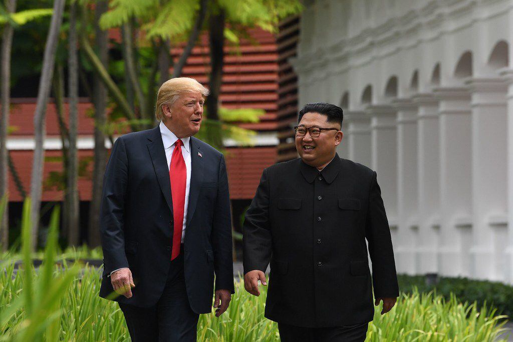 TOPSHOT - North Korea's leader Kim Jong Un (R) walks with US President Donald Trump (L)...
