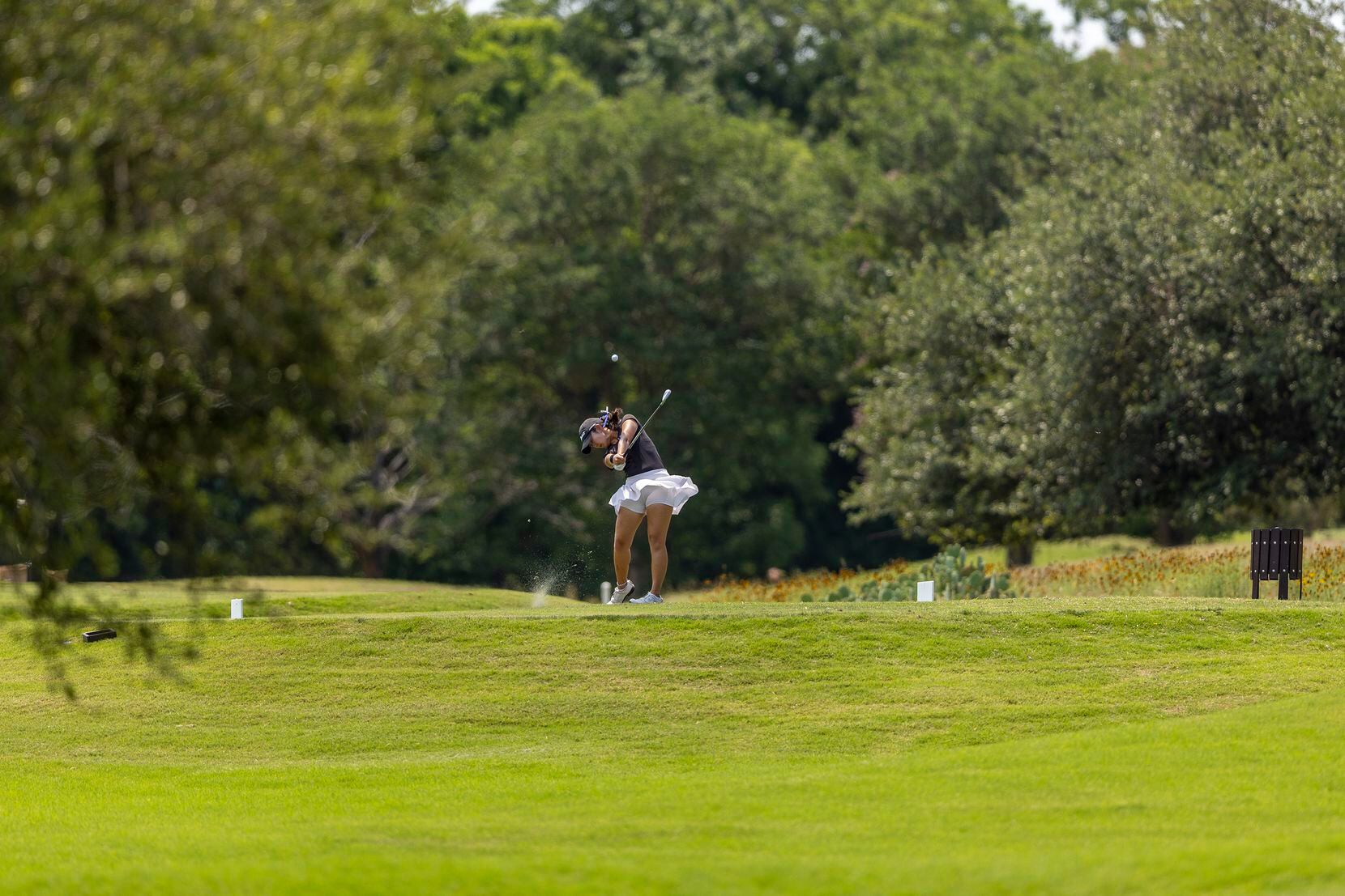 Hebron’s Estelle Seon hits from the 8th tee box during the 6A girls state golf tournament in...