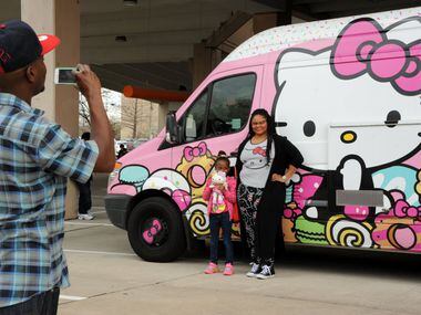 Dakota Bradford and Devon Warner pose for a picture with the famous truck at the Hello Kitty...