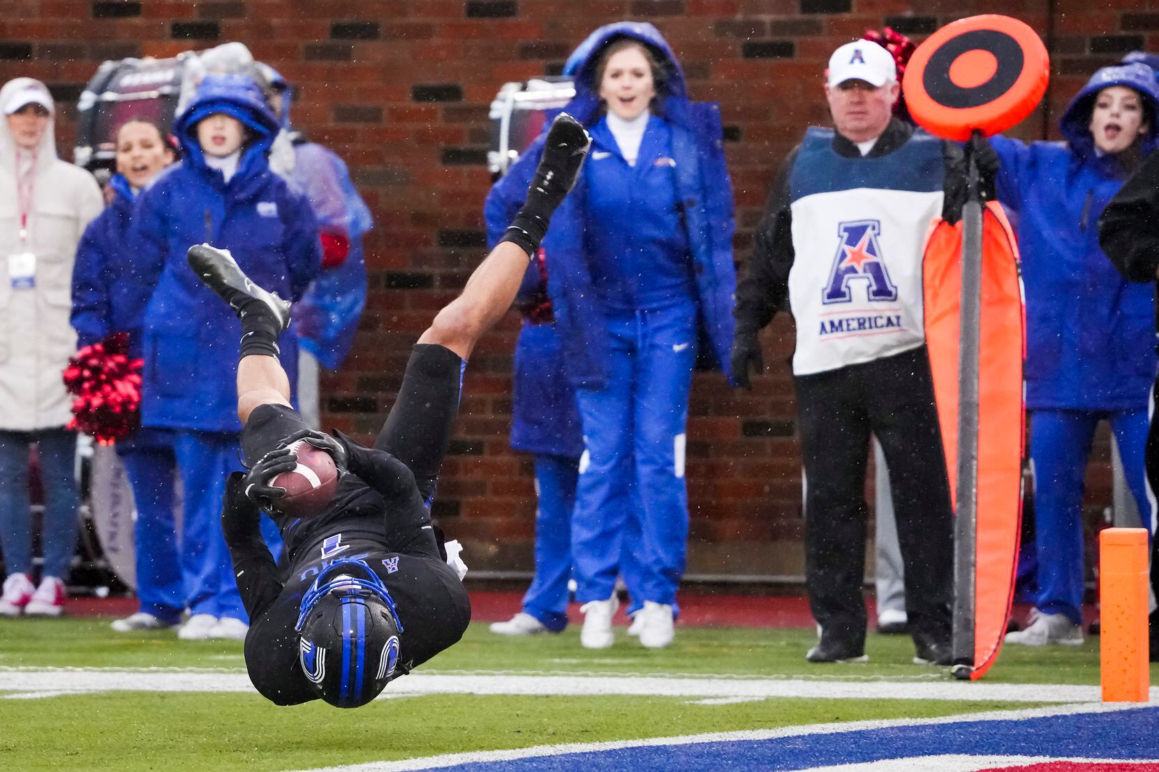SMU wide receiver Jordan Kerley flips toward the end zone after being knocked off his feet...