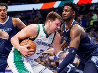 Dallas Mavericks guard Luka Doncic (77) collides with Memphis Grizzlies forward Jaren Jackson Jr. (13) during the second quarter at the American Airlines Center on Sunday, Jan. 23, 2022 in Dallas.
