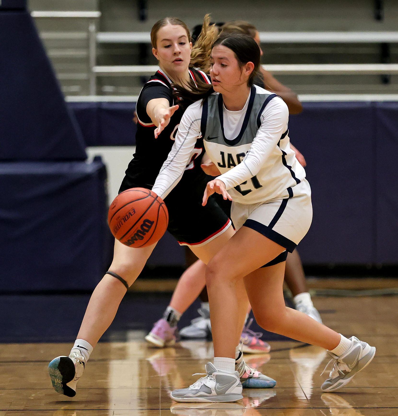 Flower Mound guard Kaitlyn Meche (21) tries to make a pass against Coppell guard Landry...