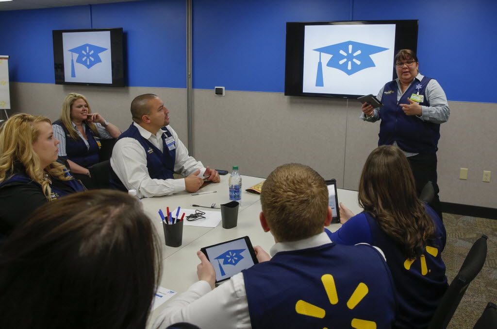 Pierette Rivera, standing far right, a training facilitator at Wal-mart Academy, worked with...