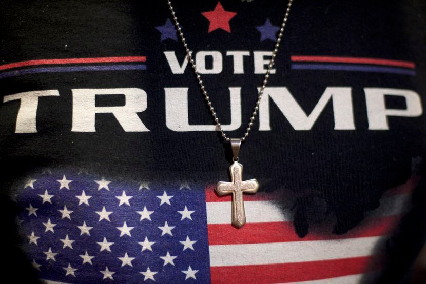 Minister E.J. Christian, 68, wears a Donald J. Trump themed shirt with a cross necklace...
