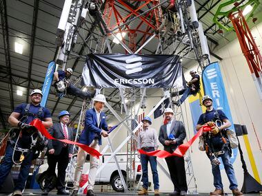 Ericsson's North American CEO Niklas Heuveldop (third from left) cuts the ribbon on the new...