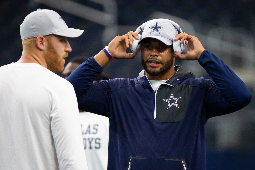Dallas Cowboys quarterback Dak Prescott (right) talks with quarterback Cooper Rush before a...