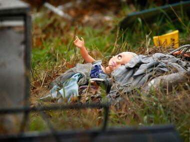 A child's doll is seen among the debris in the front yard of a wrecked home in the 3500...